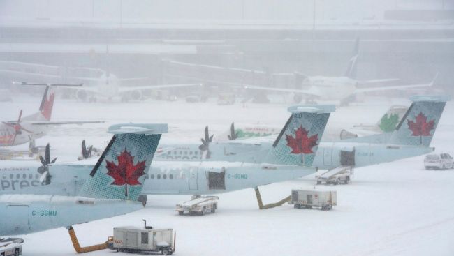 Snowstorm wreaks havoc on air travel plans, as hundreds more flights cancelled