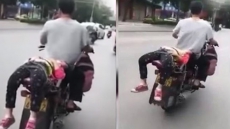 VIDEO: Father Ties Daughter On His Bike As She Refuses To Go To School
