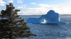 Iceberg With Archway In Centre Draws Onlookers To Eastern Newfoundland Cove