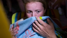 Annaleise Carr powers through the night to finish marathon swim across Lake Erie