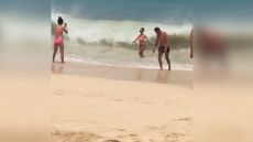 WATCh: Woman Poses For A Photograph On The Beach, What Happens Next Will Leave You In Splits