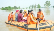 Riding boat, Punjab CM visits flood-hit areas