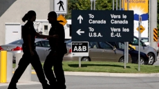 Canadian shot by U.S. border guards after pointing gun is charged in Windsor, Ont