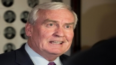 Higgs tries to focus attention on his COVID record