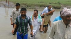 J&K: Photo of BJP MLA Crossing River On Policeman’s Back Goes Viral