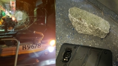 Multiple vehicles damaged by rocks thrown from pedestrian overpass