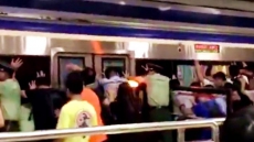 VIDEO: Beijing Crowds Push Train to Free Man Stuck in Platform Gap