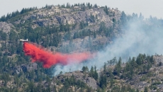 Crews race to put out fire fanned by winds