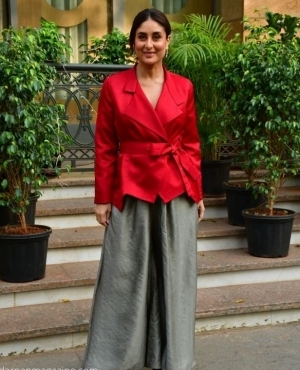 Kareena Kapoor goes for a deep red blazer with wide pants to mark the holiday season 