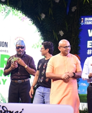 Jackie Shroff holds a plant on stage at the Bhoomi Namaskar Campaign 