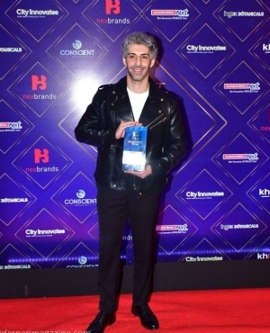 Jim Sarah poses with his award 