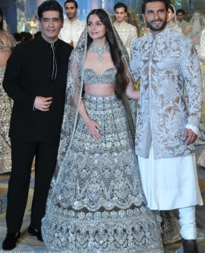 Designer Manish Malhotra, Alia Bhatt, and Ranveer Singh pose together 