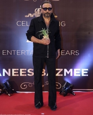Jackie Shroff arrives with a plant his signature look