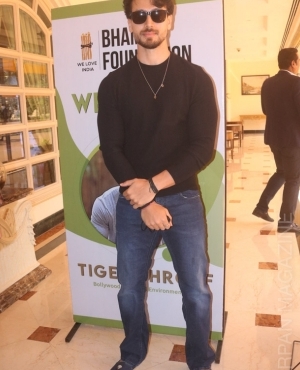 Tiger Shroff poses with placard and sunglasses 