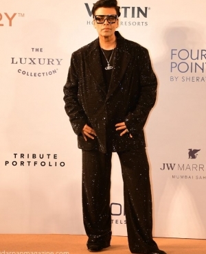 Karan Johar looks classy in black with black rimmed glasses 