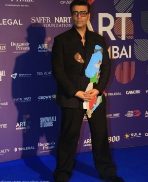 Karan Johar poses for the press with his chic glasses 