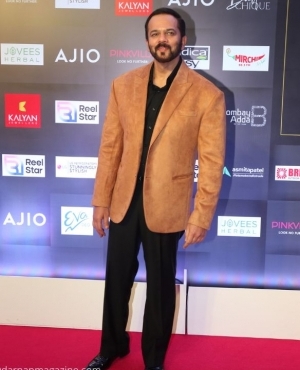 Director Rohit Shetty goes for a camel coloured blazer with shiny shoes 