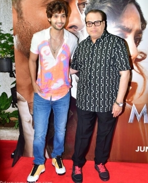 Ramesh S Taurani and guest pose on the red carpet 