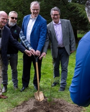 NDP MLA's Garry Beggs, Bruce Ralston, and Mike Starchuk pose with a shovel in the ground  