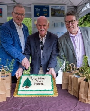 NDP MLA's Garry Beggs, Bruce Ralston, and Mike Starchuk cut a cake to mark the 10th billion tree planting event 