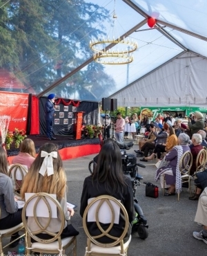 Community members with scholarship recipients seated on the side 