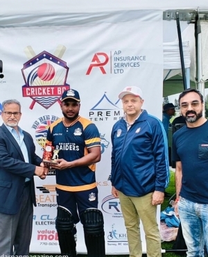 Cricket Canada President Amjad Bajwa presents a trophy to one of the players. Alongside is the coach and Cricket BC President Vimal Hardat 