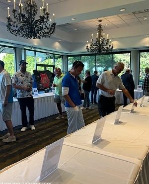 Golfers look at the auction items 