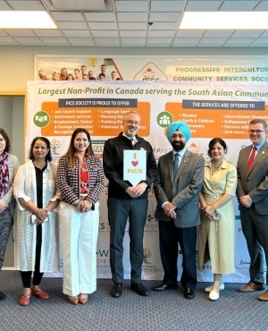 Jim DeHart poses with PICS staff 