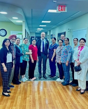 Jim DeHart poses with staff at Guru Nanak Diversity Village 