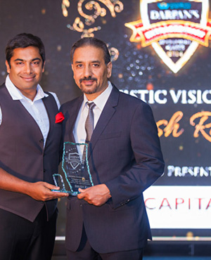 Sirish Rao receives the Artistic Visionary Award from Gurjinder Rana, owner Capital Stone & Tile