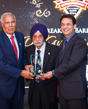 Dr. Gurdev S. Gill receives the Breaking Barriers award from Paul Bhogal and Sohan Bhogal, founders, Sunrise Kitchens