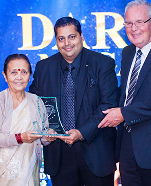 Anuradha Koirala receives the International Sensation award from Canadian Western Bank executives, Puneet Agrawal, Director of Business Development, and Bob Duffield, General Manager