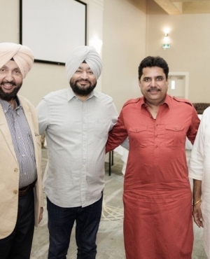 Media personality Harjinder Thind poses with attendees at the event 