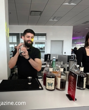 Two happy bartenders serve up drinks to the attendees 