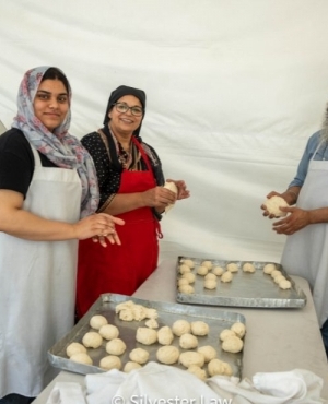 Guru Nanak's Free Kitchen staff hard at work making meals for the volunteers and staff hard at work 