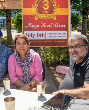 MLA Jinny Sims poses with staff and volunteers 