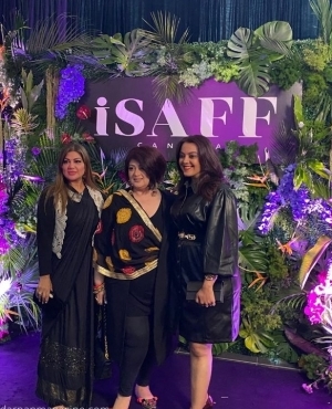 Attendees pose on the purple carpet 