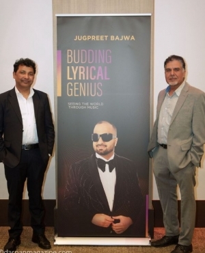 Audience poses besides Bajwa's poster 