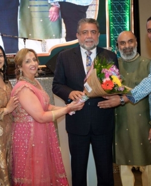 Garry Sangha of Crystal Consulting Group of Companies presents a bouquet to MP Sukh Dhaliwal 