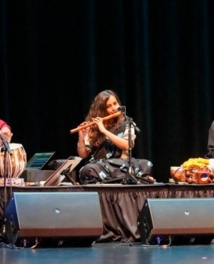 Orchestra showcase their talent with tabla, flute player, and singer 