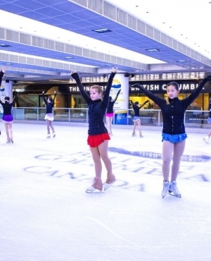 Young skaters and Minister get ready to get on the ice 
