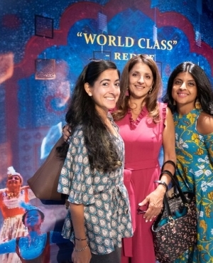 More audience members take pics in front of the poster 