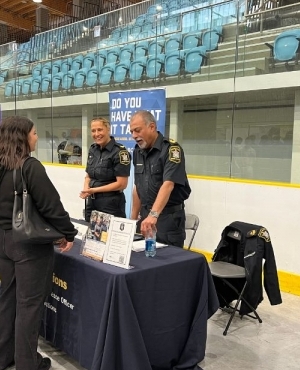 Attendees speak to exhibitors 