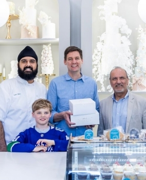 Owner of Mann's bakeshop and baker, Jujhar Mann, Premier David Eby, Premier David Eby's son, and Labour Minister Harry Bains 