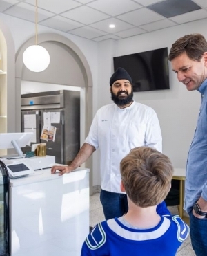 Premier Eby looks at all the baked goods in the glass case 