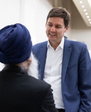 Premier David Eby attends to the guests present 
