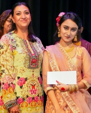 Neera Agnihotri of Agnihotri Immigration presents a token to Meera Mehzabin 