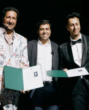 Sulaiman Merchant and Salim Merchant on stage being honoured by MP Taleeb Noormohamed 