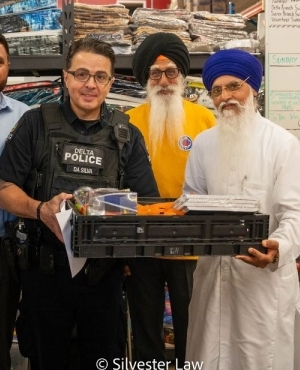 Delta Police officer poses with some of the volunteers at GNFK 