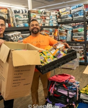 Another Delta Police officer and a GNFB volunteer load up on supplies 